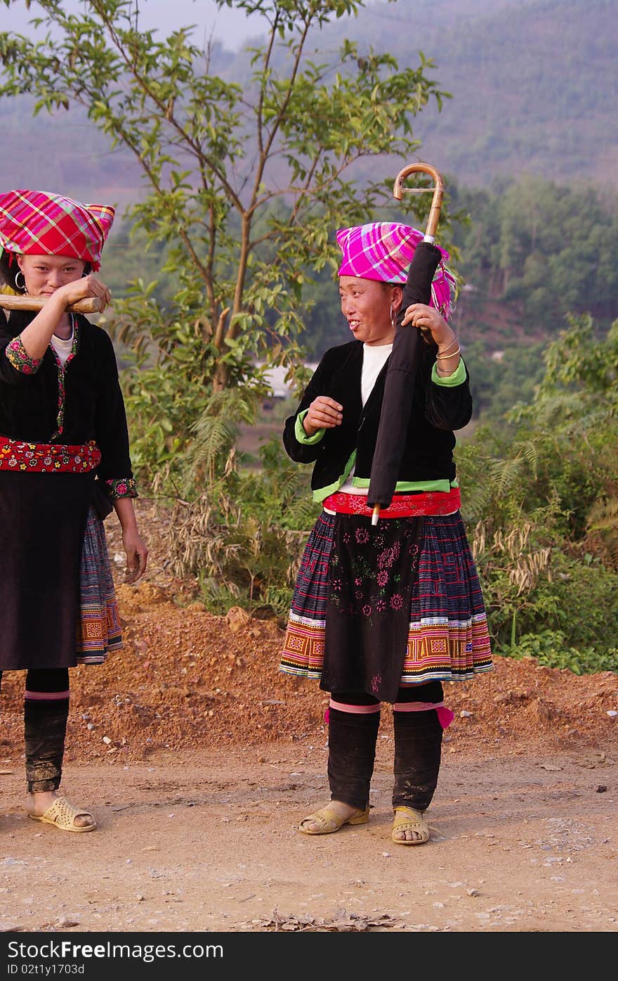 Two young women returning from the fields. Their dress is not folklore they wear daily to work. Two young women returning from the fields. Their dress is not folklore they wear daily to work