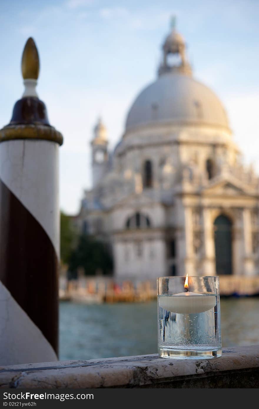 Floating candle with Basilica background  in Venice at dusk. Shallow depth of field