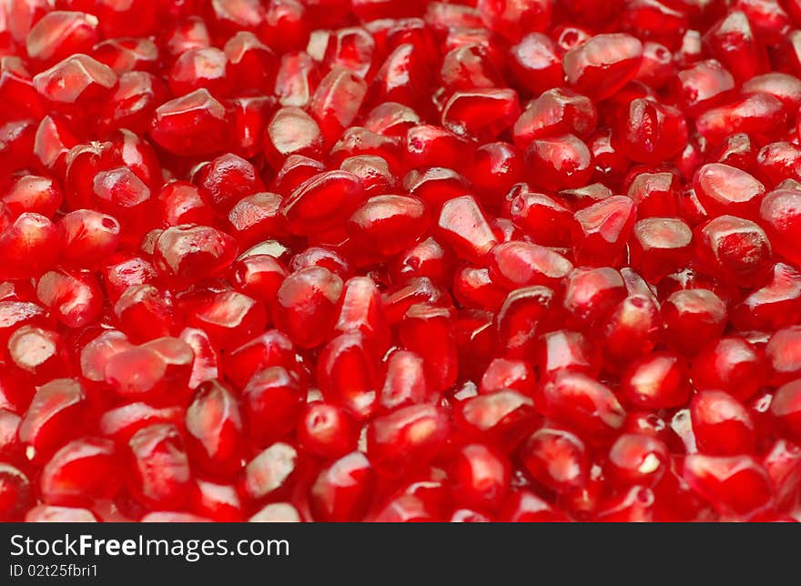 Macro of peeled ripe seeds pomegranate background