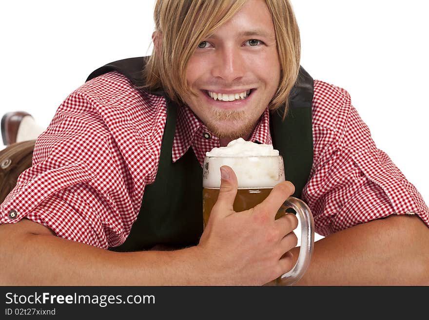 Man lying on floor holds oktoberfest beer stein