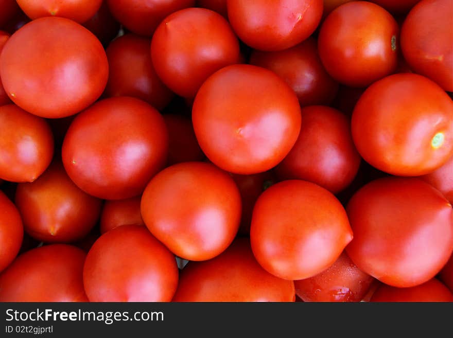 Organically grown red cherry tomatoes background. Organically grown red cherry tomatoes background