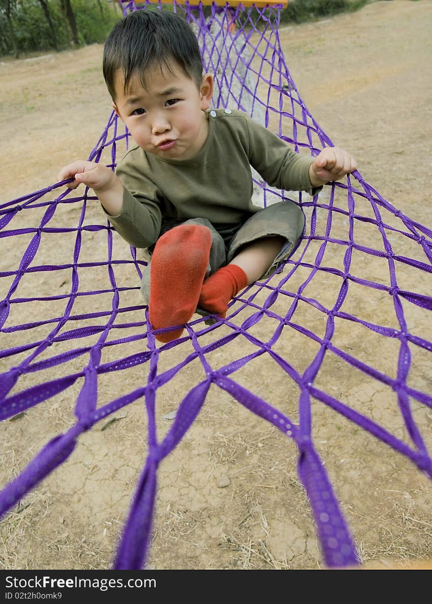 Boy making faces in hammock