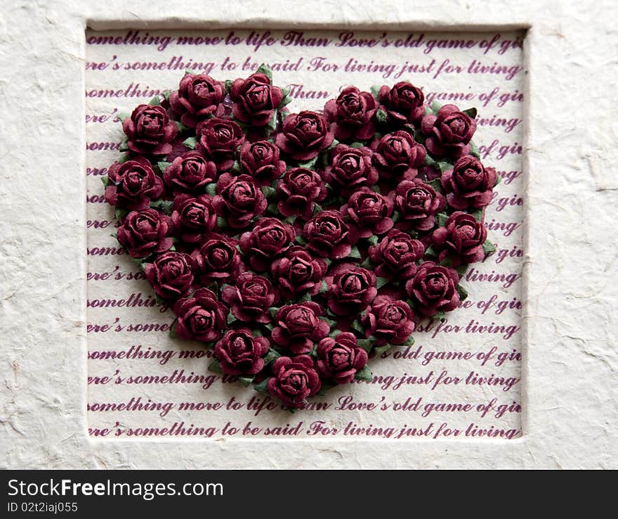 Paper flowers in heart form in wedding album. Paper flowers in heart form in wedding album