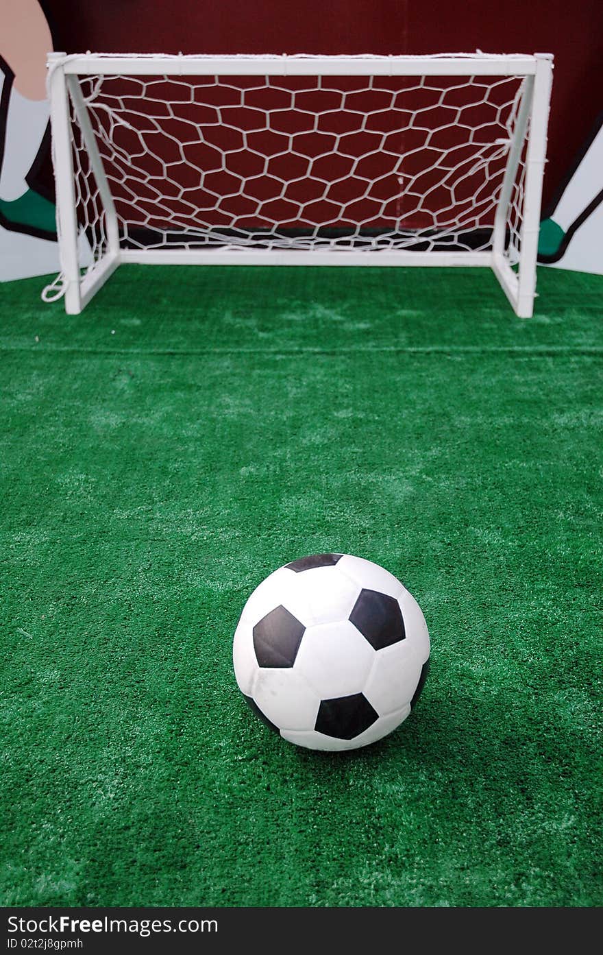 Soccer ball against the goal net in the grass. See more soccer photos in my portfoli. Soccer ball against the goal net in the grass. See more soccer photos in my portfoli