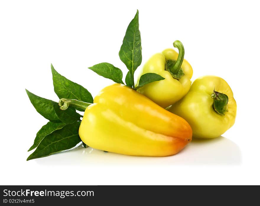 Yellow pepper and green leaf isolated on white background