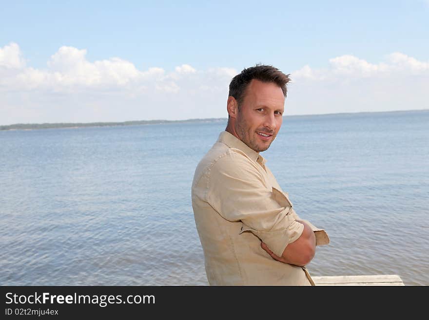 Man standing by a lake