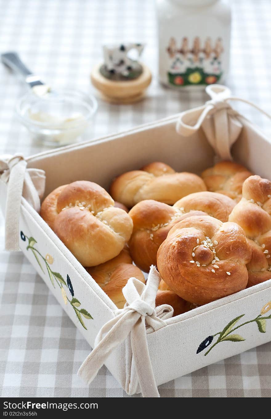 Tied buns  over bread plate with butter