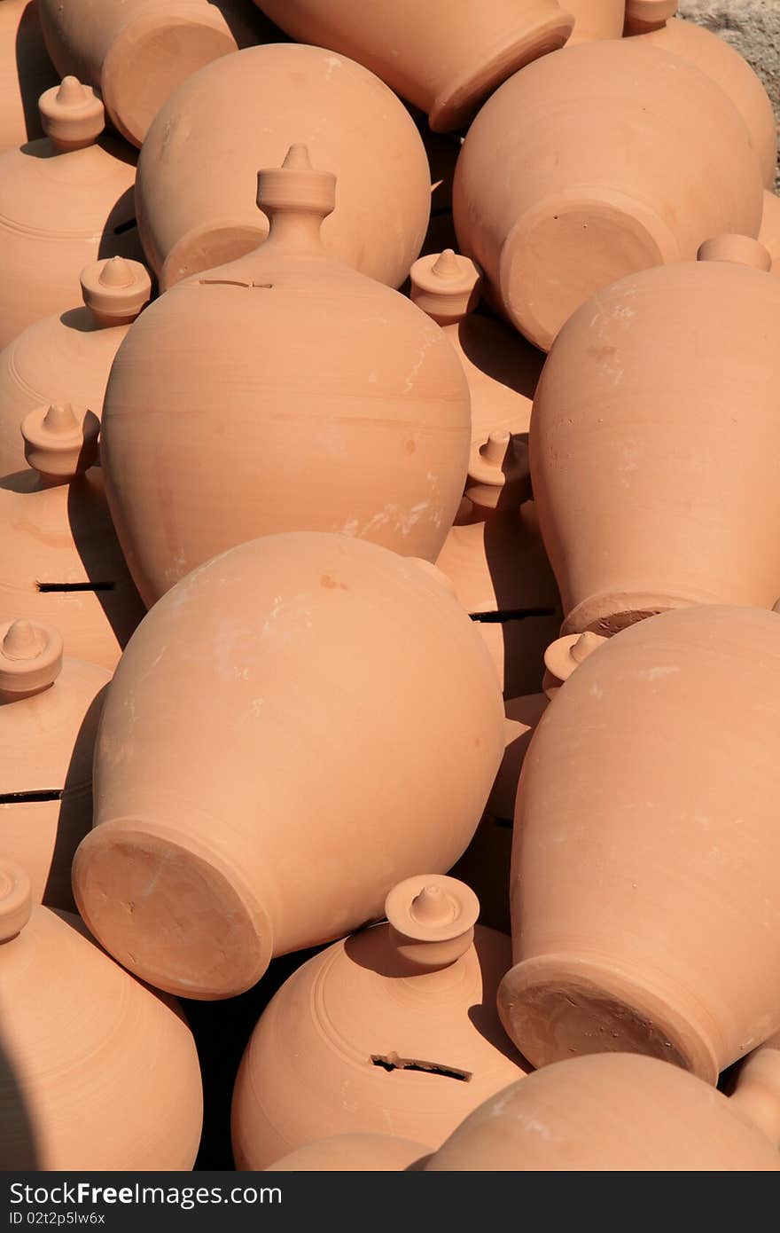 Stall of raw clay moneyboxes at a village fair. Stall of raw clay moneyboxes at a village fair