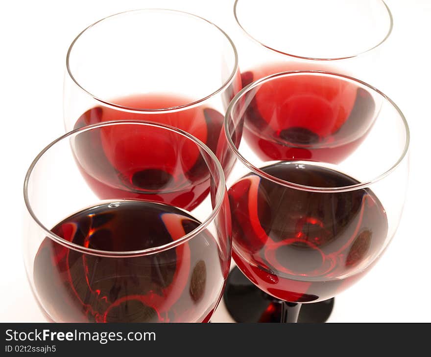 Big glass and bottle of red wine over red background. Big glass and bottle of red wine over red background