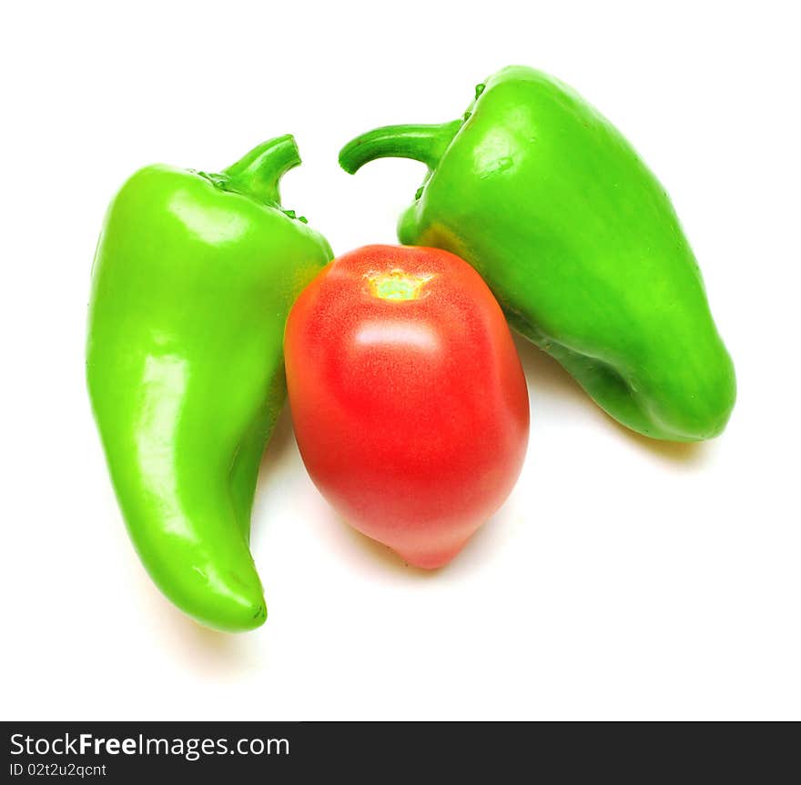 Green pepper and tomato on white background