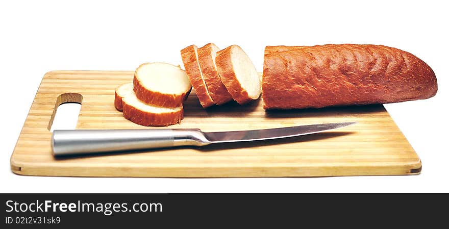 Baguette sliced with a knife isolated on white