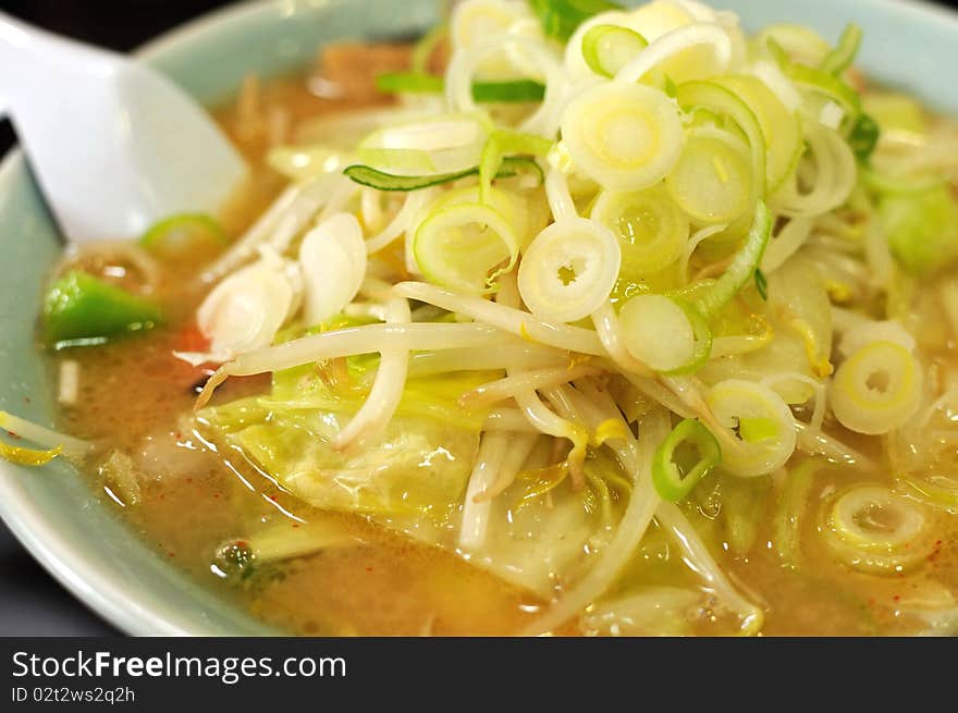 Japanese traditional miso noodles generously topped with onions and vegetables. Suitable for concepts such as diet and nutrition, healthy lifestyle, and food and beverage. Japanese traditional miso noodles generously topped with onions and vegetables. Suitable for concepts such as diet and nutrition, healthy lifestyle, and food and beverage.