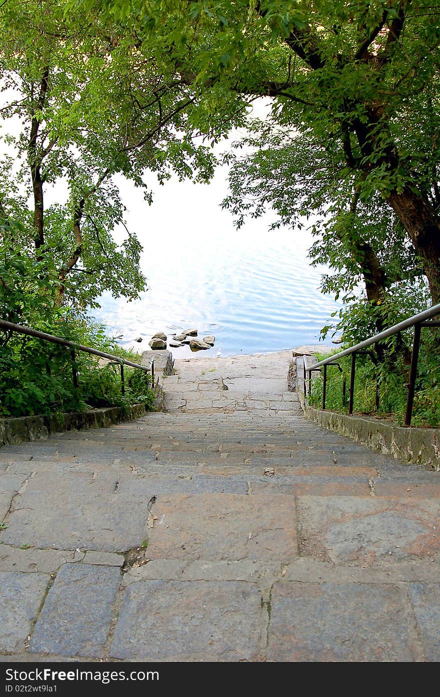 Stone steps conducing to water on nature