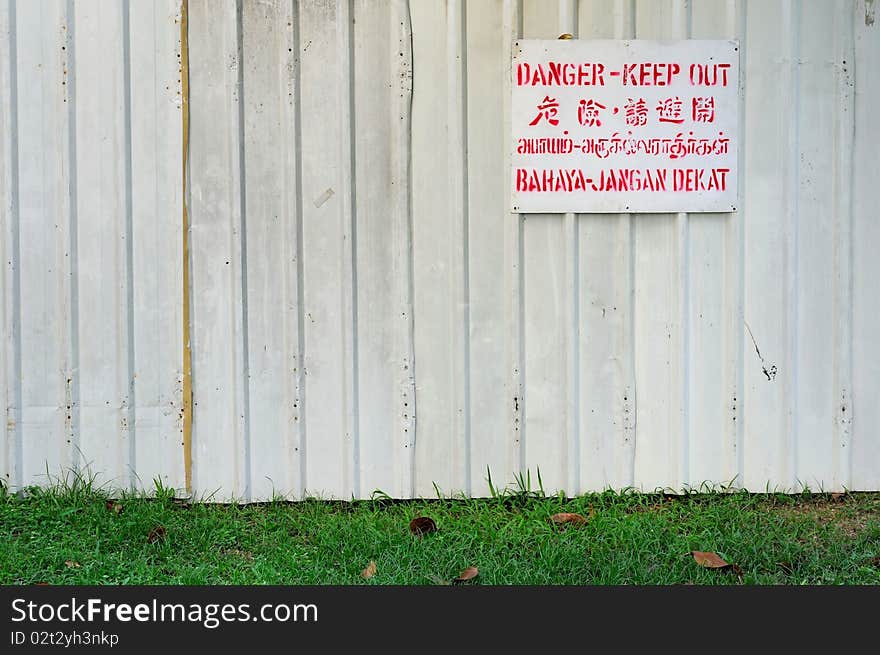 Danger Signboard On White Fence