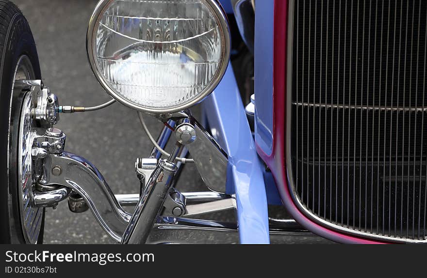 Closeup of a classic vintage car displayed outdoors.