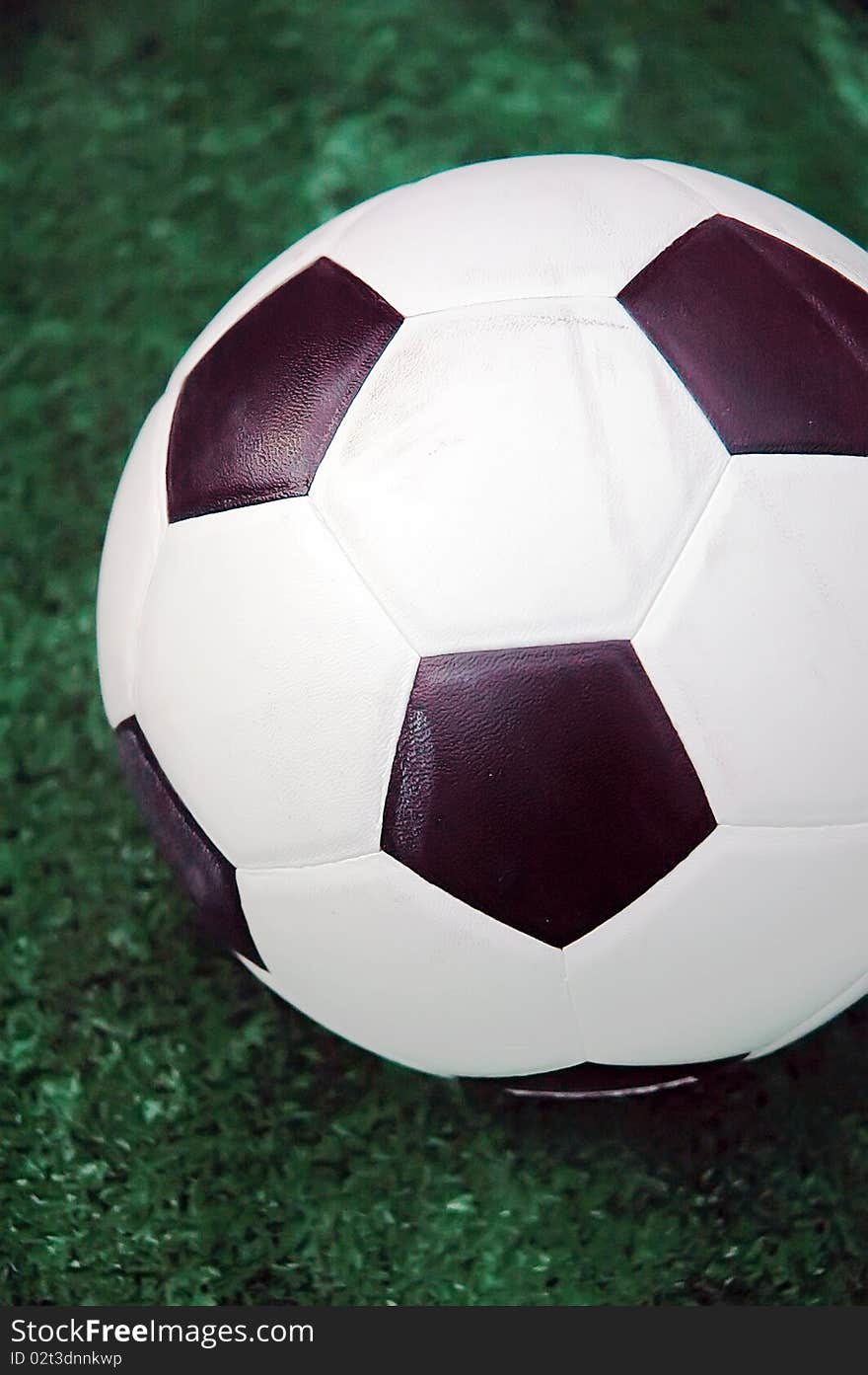 Soccer ball against the goal net in the grass. See more soccer photos in my portfoli. Soccer ball against the goal net in the grass. See more soccer photos in my portfoli