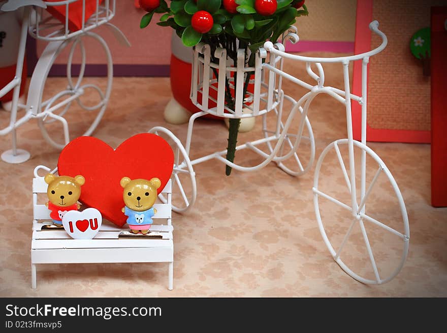 Two bears on chair in garden. Two bears on chair in garden