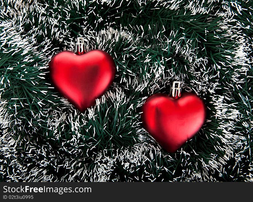 Christmas tree decorations. Toy in the shape of the heart and tinsel.