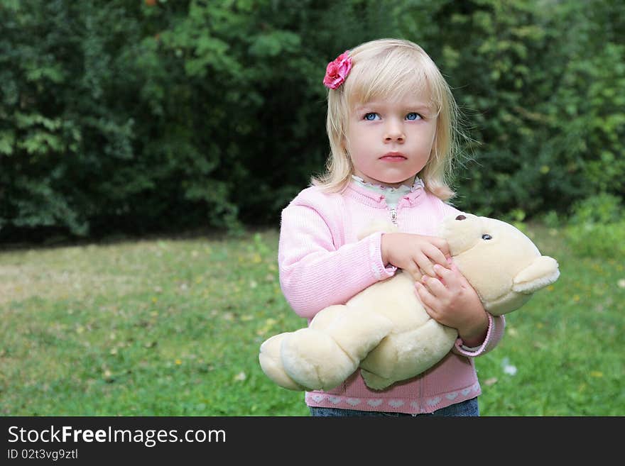 Baby girl holding her toy bear