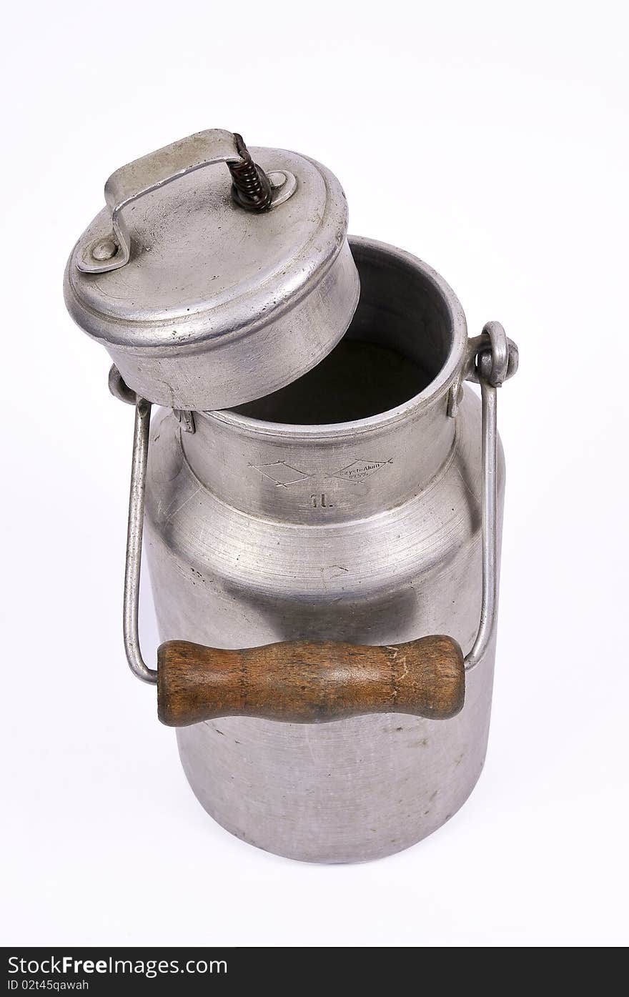 Studio shot of an old and worn out milk can with a handle. Studio shot of an old and worn out milk can with a handle