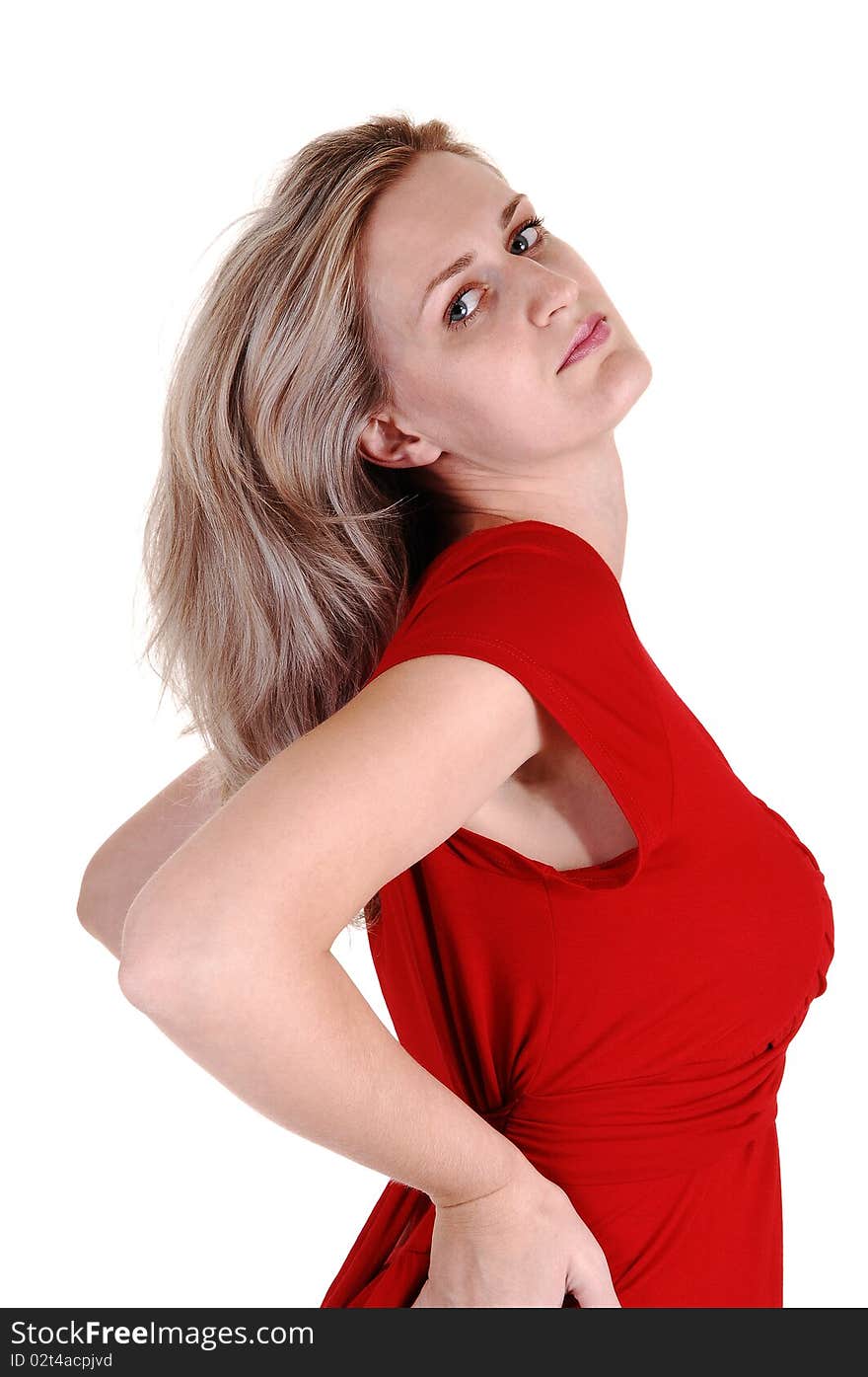 An very pretty tall woman in a red dress standing in the studio with with her long white blond hair, looking into the camera, for white background. An very pretty tall woman in a red dress standing in the studio with with her long white blond hair, looking into the camera, for white background.