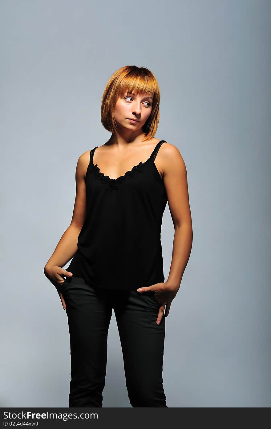 Young women's portrait on the gray background