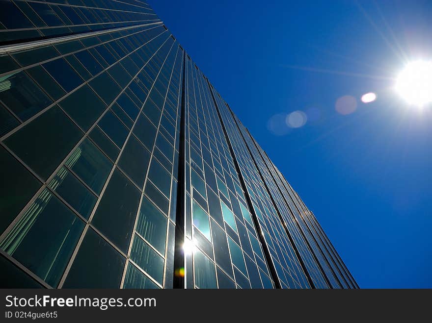 Sun shining on a building in a city. Sun shining on a building in a city