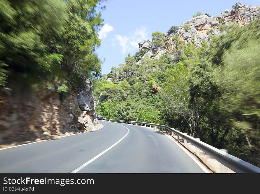 Driving along the road between mountains