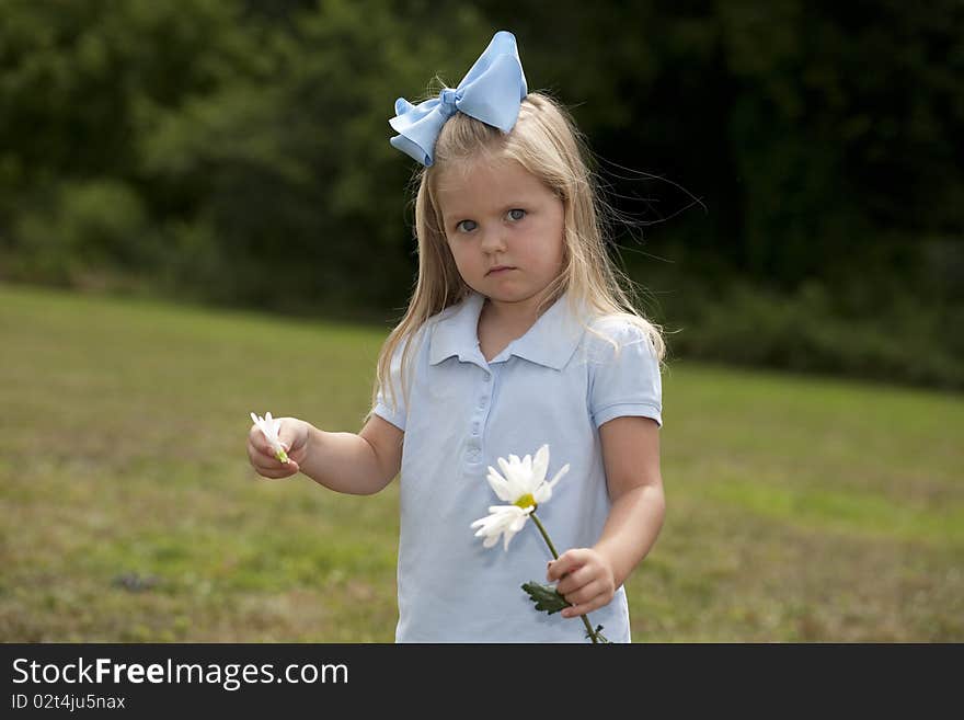 Little Girl Holding a Flower