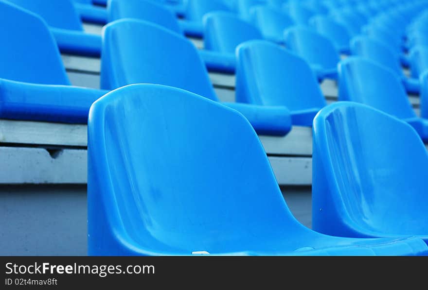 Empty blue plastic football stadium seats. Empty blue plastic football stadium seats