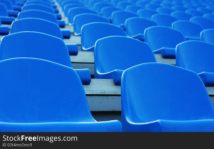 Empty blue plastic stadium seats