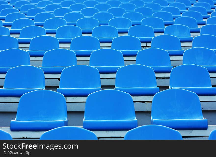 Empty blue plastic stadium seats