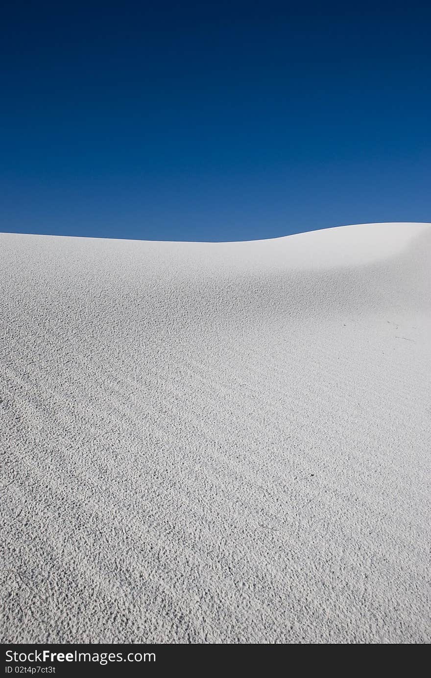 A white sand dune in a vast desert. A white sand dune in a vast desert