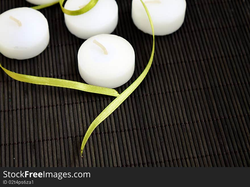 White candles on black background