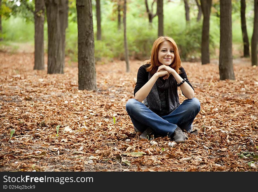 Beautiful Red-haired Girl In Autumn Park