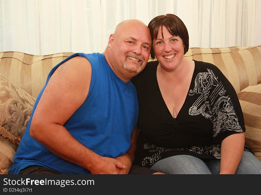 Couple sitting close to each other smiling