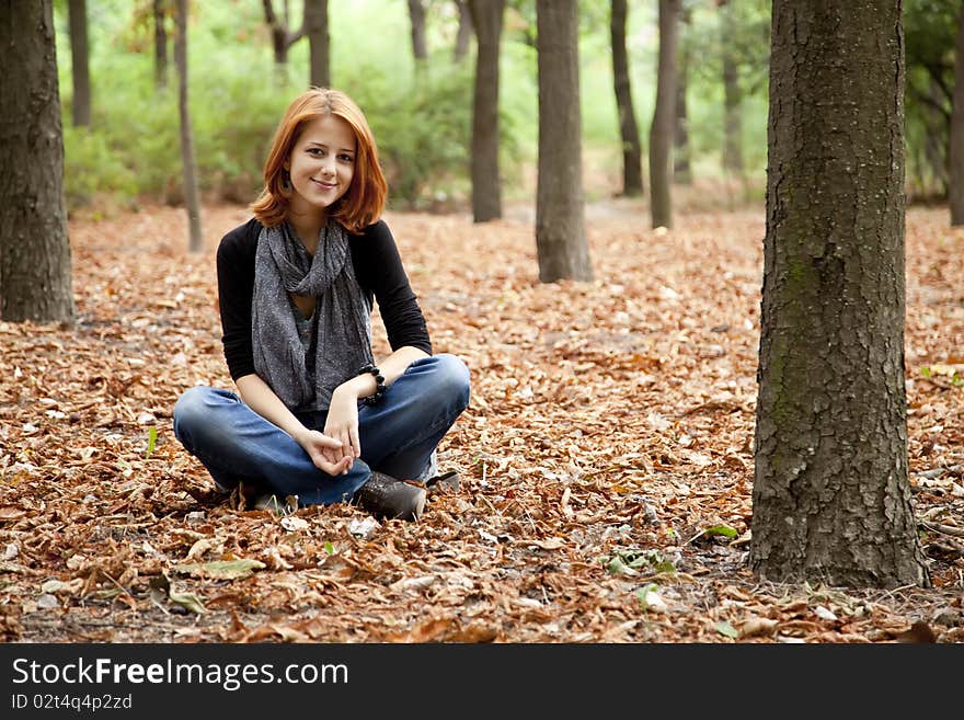 Beautiful Red-haired Girl In Autumn Park