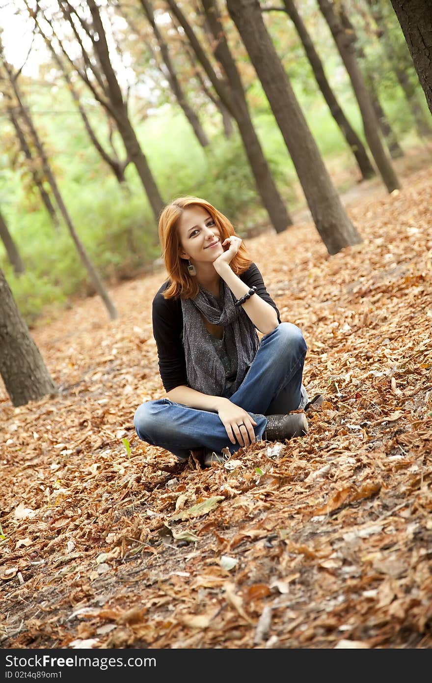 Beautiful Red-haired Girl In Autumn Park