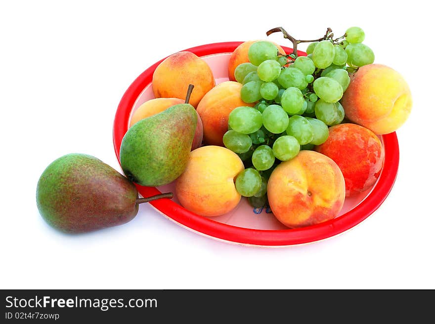 Grapes, peaches and pears in the tray isolated on the white