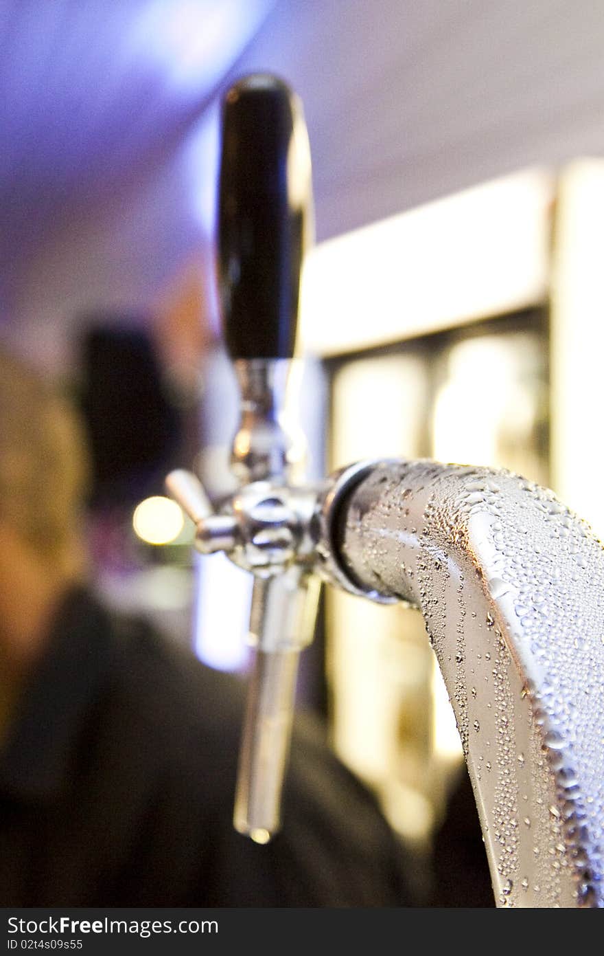 Draught beer spout covered with condensation. Draught beer spout covered with condensation