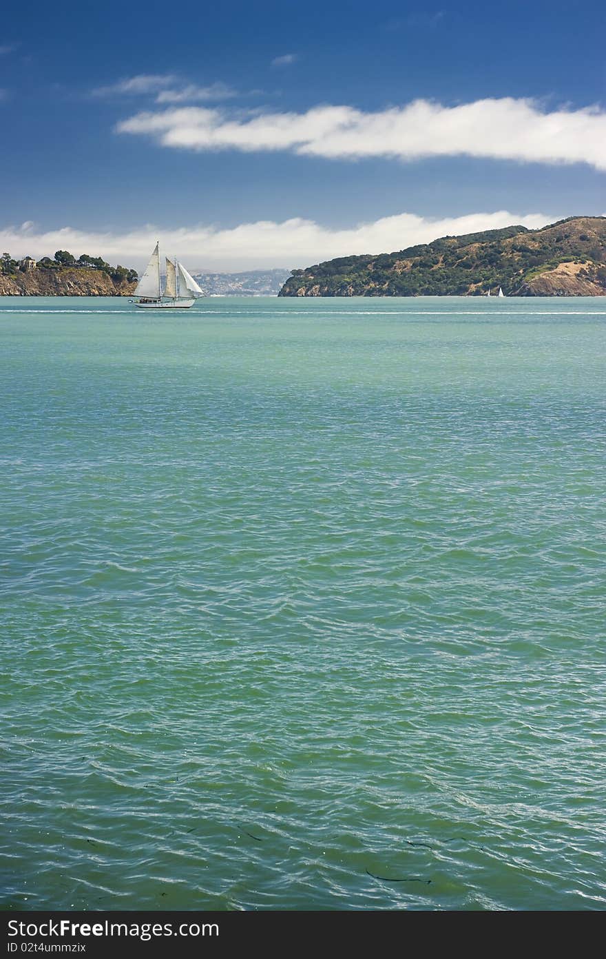 Small yacht sailing along the coast