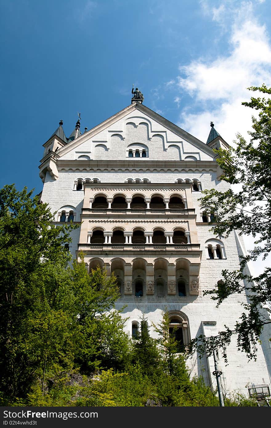 Wall of a castle in the forest with a balcony