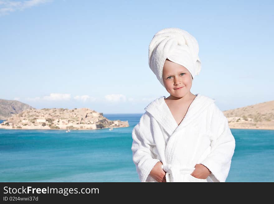 Little girl with towel on head in white bathrobe