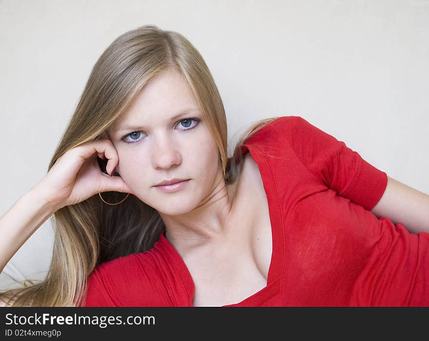 Cute thoughtful girl in red blouse