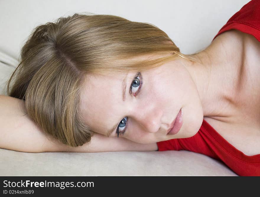 Beautiful dreamy girl lying on her hand