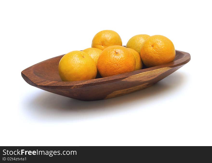 Handcrafted wooden fruit dish with oranges isolated on white. Handcrafted wooden fruit dish with oranges isolated on white