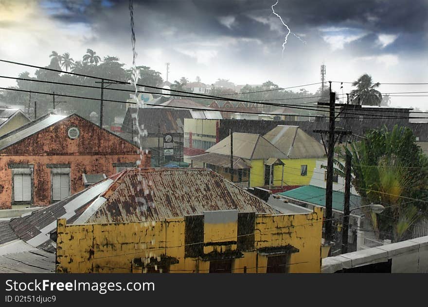 A tropical rainstorm over simple village with tin roofs