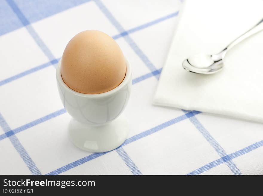 Breakfast table with a fresh egg