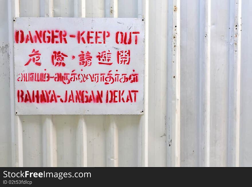 Danger Signboard On White Fence