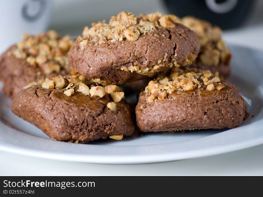 Plate of chocolate cookies with hazelnut.